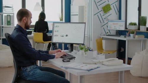 Man Working at Computer in Bright Modern Office
