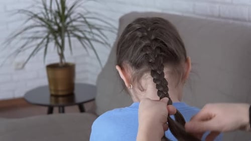 Child's Hair Braided Indoors in Daytime