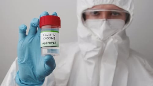 Health Worker Holding Covid Vaccine Bottle