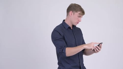 Man Using Mobile Phone Expressing Negative Reaction