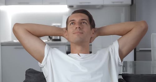 Young Man Relaxing on Couch at Home