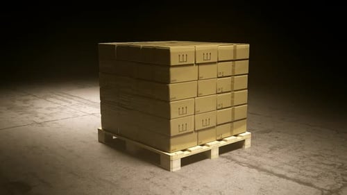 A stack of cardboard boxes on a pallet in the warehouse waiting for a forklift.
