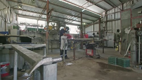 Slow motion of a welder welding construction steel frames