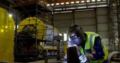 Male engineer using welding torch 4k