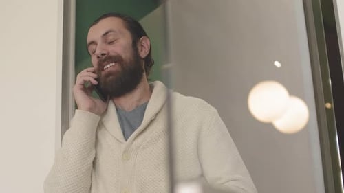 Bearded Man Talking on Cell Phone Indoors
