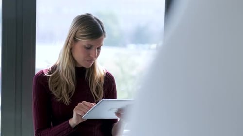 Slow motion shot of businesswoman using tablet in office