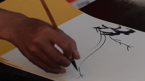 Vietnamese scholar writing calligraphy at lunar new year