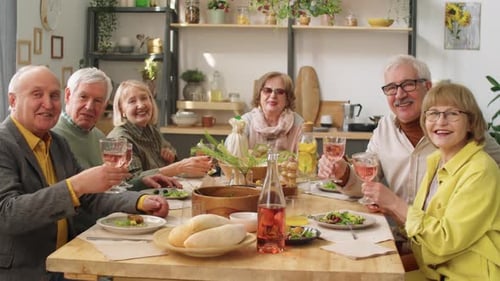 Seniors Toasting Wine Together Around the Table