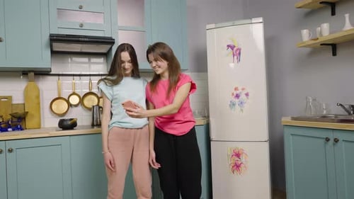 Young Women Take Selfie in Kitchen Together