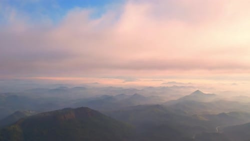 4K aerial view from a drone flying over the valley, fog in the morning.