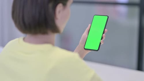 Woman Using Smartphone with Green Chroma Screen