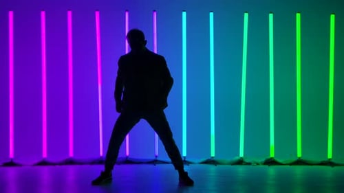 A Professional Breakdancer Performs Complex Hand Rotations. Silhouette of a Man Dancing Against the