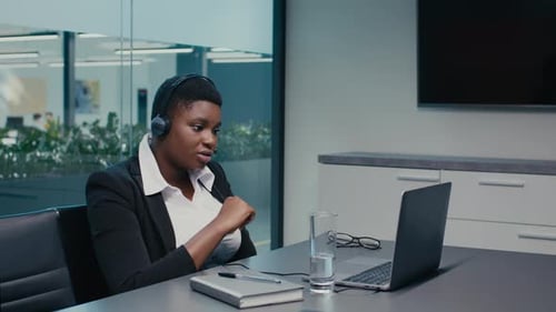 Woman in Meeting using a Laptop in Office