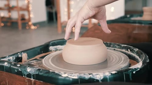 Potter Shaping Clay on a Wheel