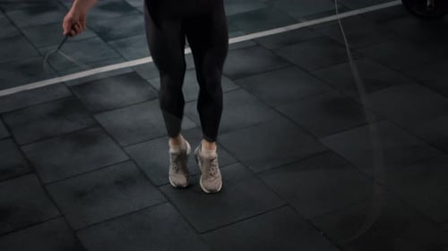 Junger männlicher Athlet trainiert Cardio mit Springseil, Cardio- und Ausdauertraining