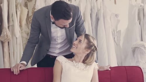 Affectionate Couple Embrace in Bridal Shop