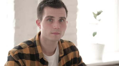 Surprised Man Looks Anxious in Modern Home