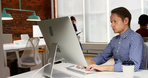 Man Working at Computer in Modern Office