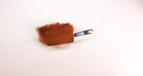 Nutmeg, myristica fragans, powder falling against White Background, Slow Motion 4K