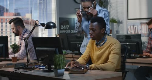 Coworkers Working Together in Bright Corporate Office