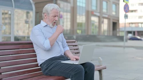 Senior Man Using Laptop on Urban Bench