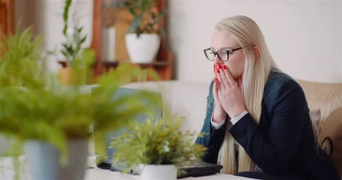 Female Entrepreneur Using Laptop In Office