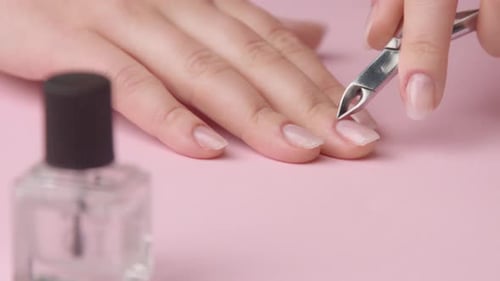 Woman Trimming Cuticles at Home Manicure