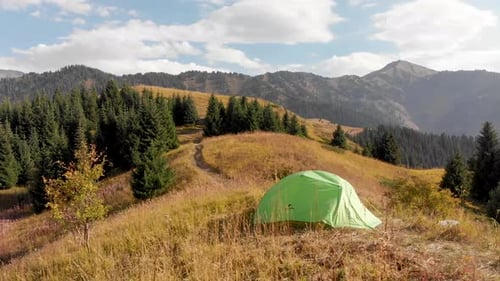 Green Camping Tent in the Mountain Forest