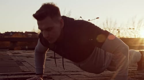 Man Exercising in City During Sunrise