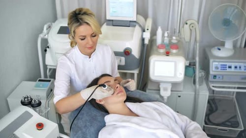 Woman Receives Facial Treatment at Medical Spa