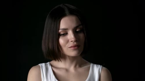 Woman Posing With Dark Hair on Black Background