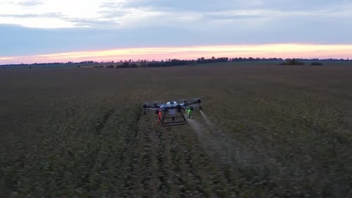 Agricultural Drone Spreading Fertilizer Over Farm Field