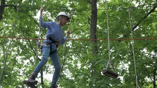 Child climbing in rope park.