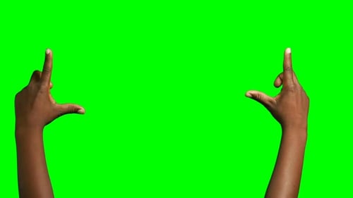 Person making hand gesture against green screen background