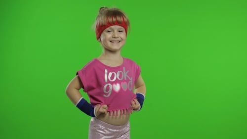 Little Girl in Pink Sportswear Tells Something and Showing Thumb Up Gesture. Chroma Key Background