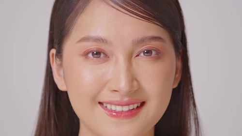 Close up on face Beautiful Asian woman looking at camera smile with clean and fresh skin Happiness