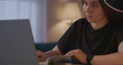 Young Woman Studying With Laptop and Notebook