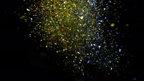 Camera follows colorful glitters flying after being exploded. Slow Motion. Unedited version ncluded.