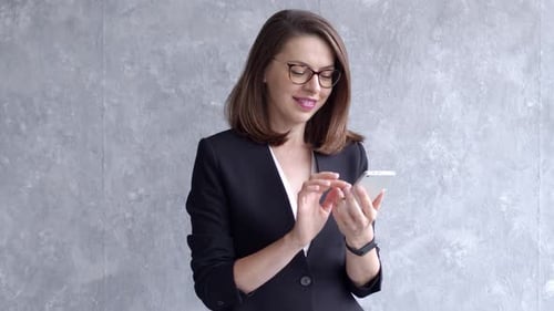 Woman Using Phone in Business Attire