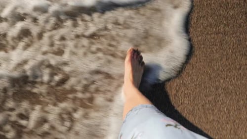 Bare Feet Walk Along Wet Sandy Ocean Beach