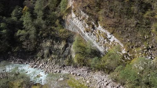 Panorama of Deep Canyon with Big Rocks and Steep Mountains
