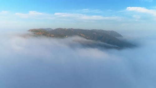 Aerial View Green Mountain Covered By Thick Fog Clouds at Sunrise. Malibu, USA