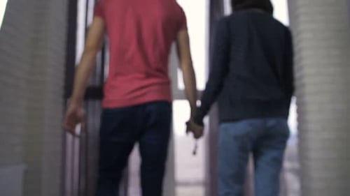 Couple Holding Hands With New House Keys