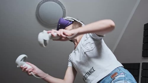 Woman Experiencing Virtual Reality with Headset and Controllers