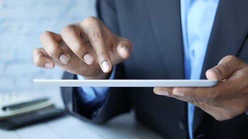 Man's Hand Working on Digital Tablet on Office Desk
