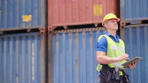 Cargo container worker or foreman walk in scene and record information of product into tablet