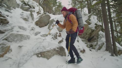 Hiker Going Down Steep Rocky Trail on Winter Day