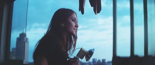 Woman photographer looking outside the balcony, close up