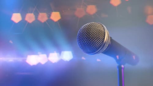 Music Concert and Close Audio Microphone on the Stage with Colorful Spotlights