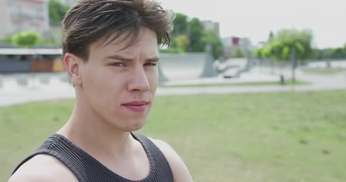 Athletic Young Man Smiling Outdoors in Park